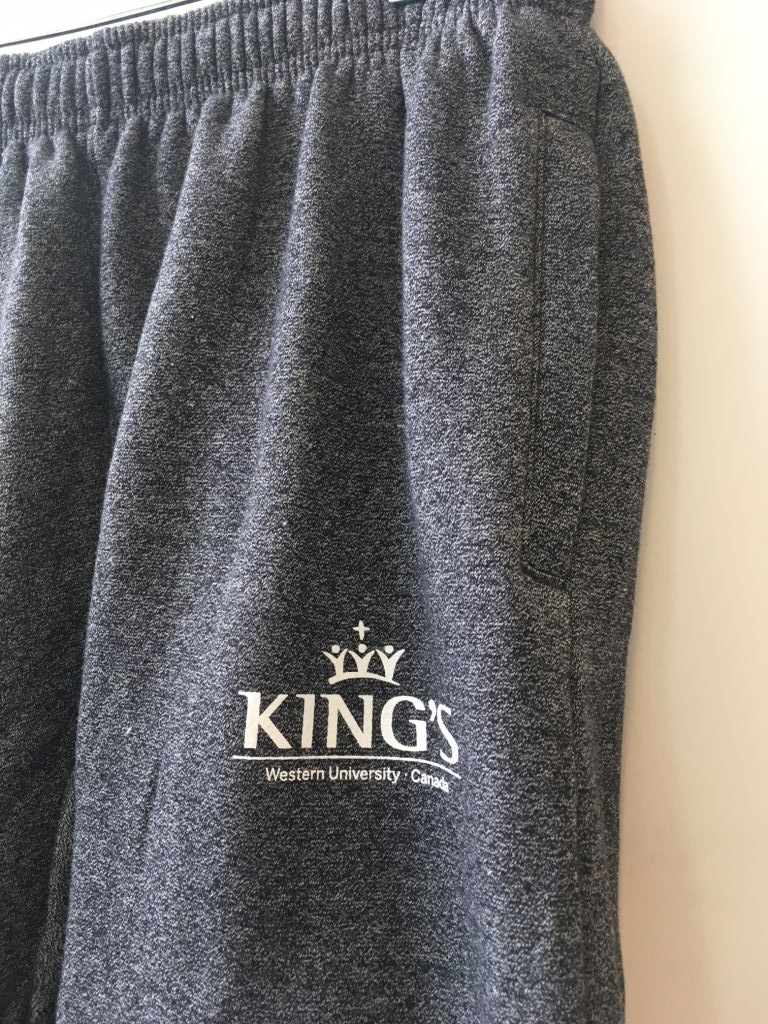 King's Sweat Pants, Charcoal Heather. Relax in our ultra cozy sweat pants with side pockets! These unisex pants are the perfect  thing for zoom meetings or lounging around after a busy day.  55% cotton, 45% polyester elastic waist with drawstring elastic cuffs