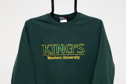 King's College Crewneck Sweatshirt, Green  Get comfortable in our unisex crewneck sweatshirt.  Sporty twill appliqué and embroidery logo makes a bold and distinctive statement. Easy care, pre-shrunk, 50% cotton, 50% polyester and machine washable.  Forest green with gold accents.
